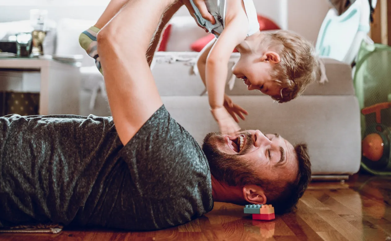 Dad and child playing on pet-proof flooring from Home Floor Designs flooring showroom in INDIANAPOLIS, IN