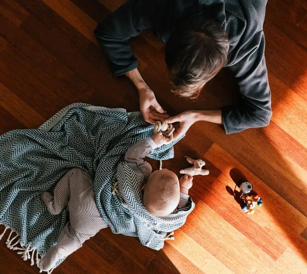 Mother and baby playing on a hardwood floor from Home Floor Designs servicing in Indianapolis and Ft. Meyers area 