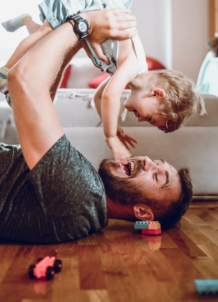Dad and child playing on pet-proof flooring from Home Floor Designs flooring showroom in INDIANAPOLIS, IN