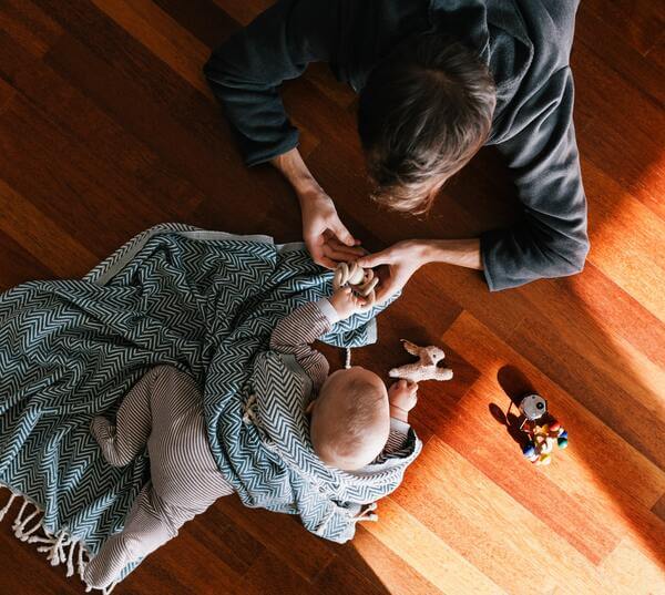 Mother and baby playing on a hardwood floor from Home Floor Designs servicing in Indianapolis and Ft. Meyers area